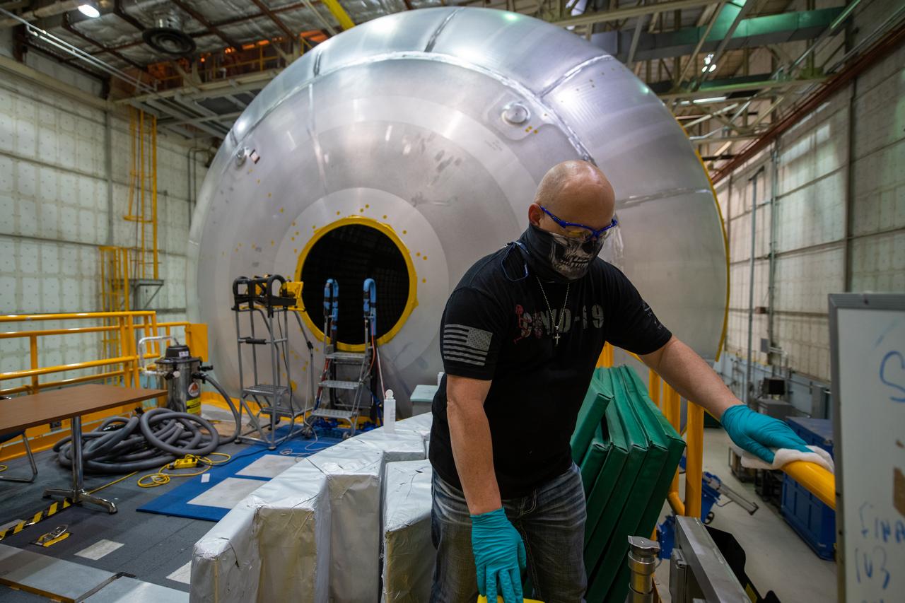 Employees wear personal protective gear at  Michoud Assembly Facility as the facility transitioned to Stage 3 of NASA’s Framework for Return To On-Site Work. Employees wear the appropriate personal protective equipment (PPE) and/or cloth face coverings as required for assigned tasks. Access to the facility is limited to authorized personnel working on mission-critical tasks that must be conducted onsite. Mission-critical tasks include slowly and methodically resuming Space Launch System (SLS) Core Stage and Orion production activities, particularly critical path deliverables to support the Artemis Program, at a pace that limits personnel and follows federal guidelines for social distancing and use of personal protective equipment such as face masks. For more information about SLS, visit nasa.gov/sls.